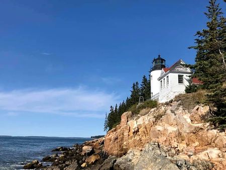 White Lighthouse, Rocky Coast — photograph by Randy Polito