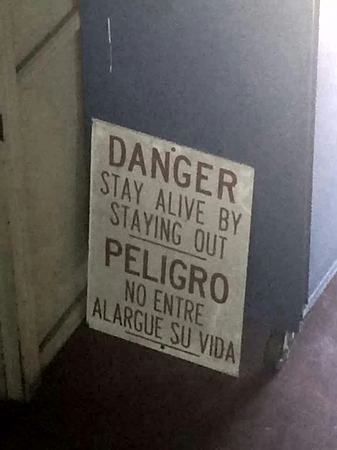 Danger, Stay Alive (Bilingual Sign) — photograph by Randy Polito