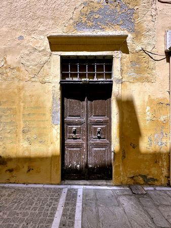Weathered Facade, Wooden Door — photograph by Randall Polito